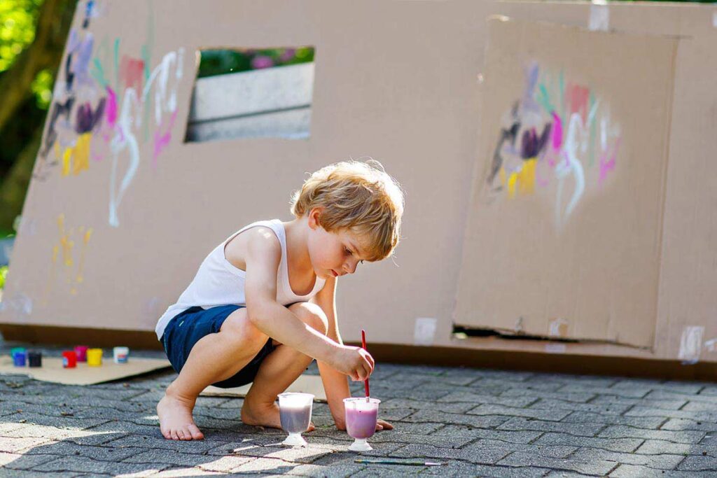 Child painting at a neighborhood event.